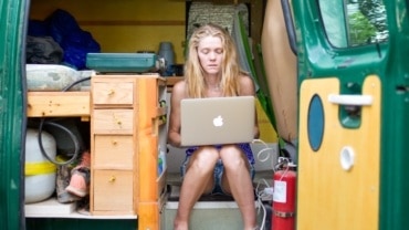 female digital nomad working on laptop