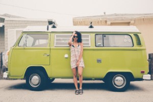 young woman in front of green vw van