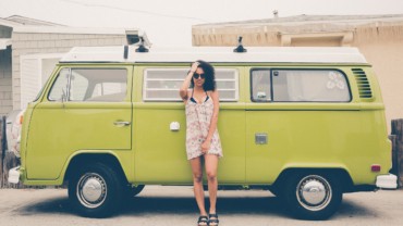 young woman in front of green vw van