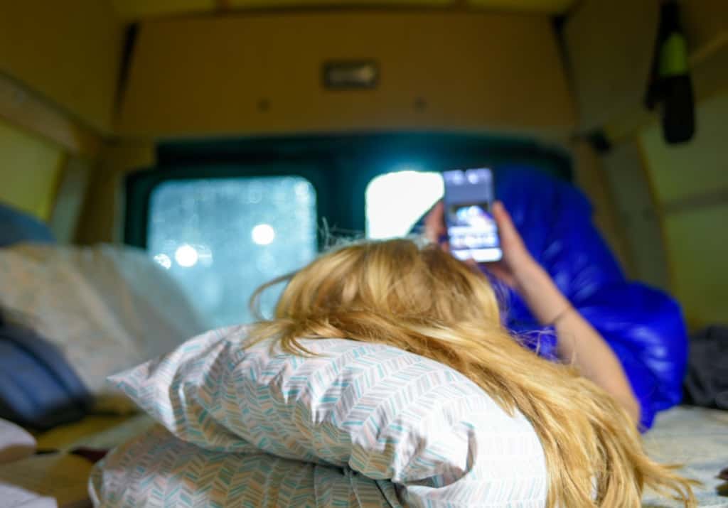 on cellphone in campervan