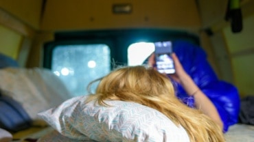 on cellphone in campervan
