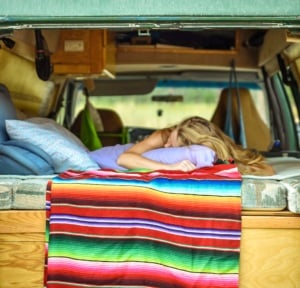 woman sleeping in a campervan