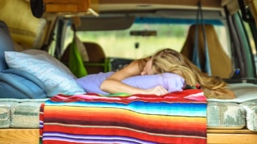 woman sleeping in a campervan