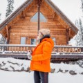 woman outside cabin in winter