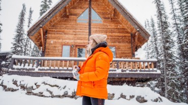 woman outside cabin in winter