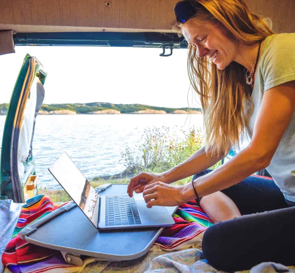 woman-in-van-working-on-laptop