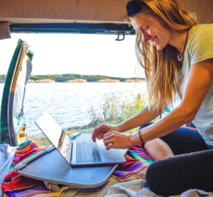 woman-in-van-working-on-laptop