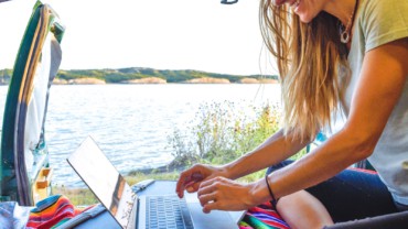 woman-in-van-working-on-laptop