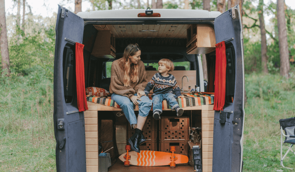 mom-and-son-sitting-in-back-of-camper-van
