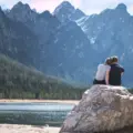 young-couple-outside-sitting-rock-min