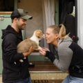 van-life-couple-playing-with-puppy-outside-van