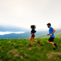 couple-running-in-field-min