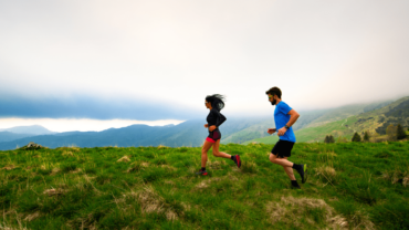 couple-running-in-field-min