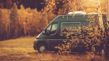 campervan-parked-in-autumnal-forest-min