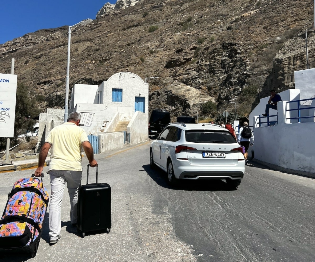 driver-carrying-luggage-to-hotel-car-santorini-ferry-port-min