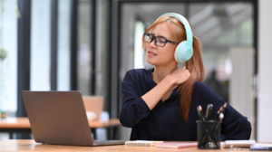 digital-nomad-female-rubbing-neck-while-on-laptop